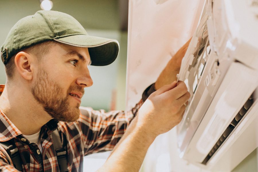 Repairman doing air conditioner servise